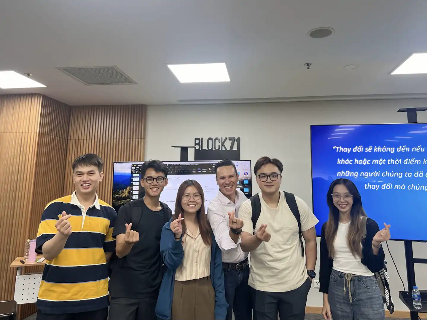 Six people, finger hearts at BLOCK71