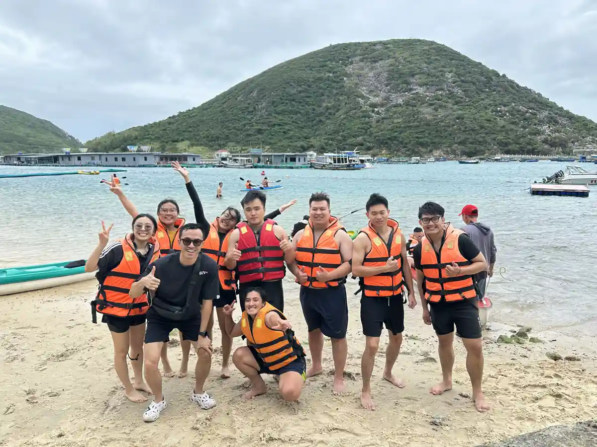 Beach kayak team in orange life jackets
